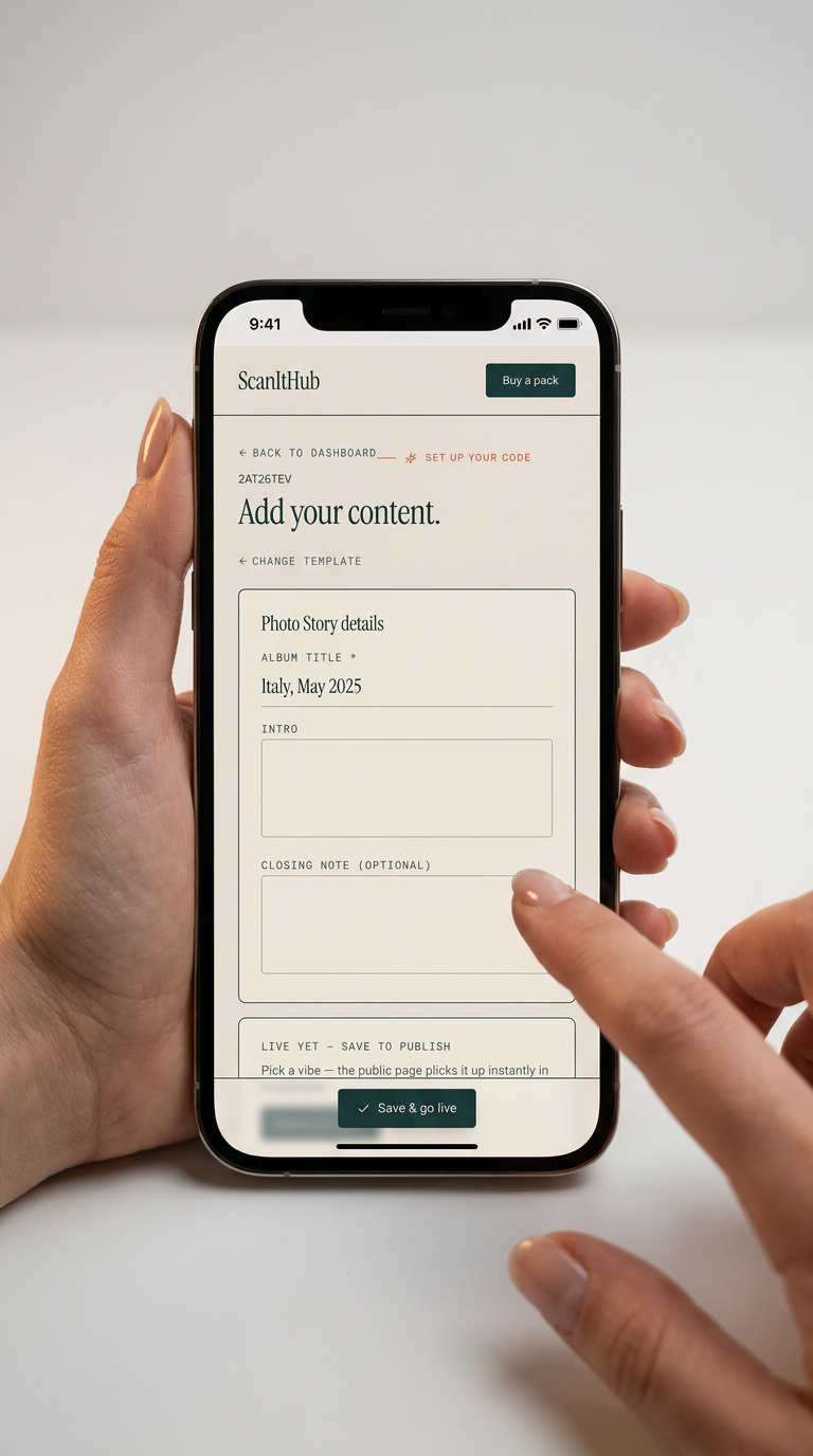 A hand holding a phone showing the ScanItHub editor — adding content to a code